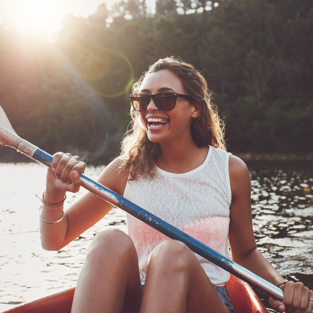 a woman rowing a boat in the water