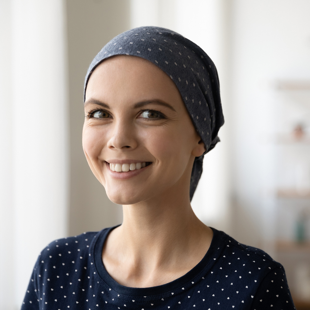 a woman wearing a hat and smiling at the camera