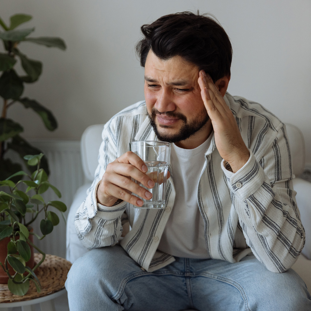a man sitting in a chair talking on a cell phone